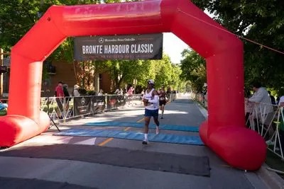 Bronte Harbour Classic 5K 2026 official race photo: Finish Line, ABAYOMI O., Mercedes-Benz Oakville, CIBC, Be Active Physio, TapeGeeks, Kids Area.
